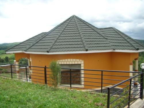 a small house with a black roof at Karobwa Summit View in Fort Portal