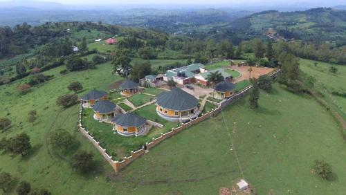 an aerial view of a house on a green field at Karobwa Summit View in Fort Portal