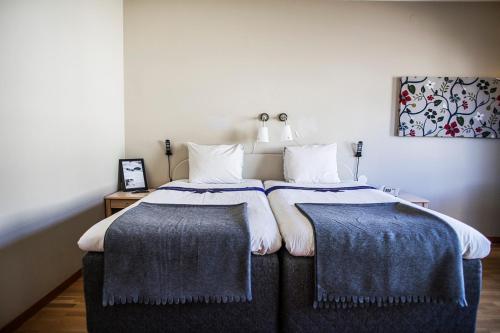a bedroom with a bed with two pillows on it at Hotel Statt Söderhamn by First Hotels in Söderhamn