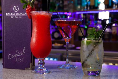 three cocktails sitting on a counter in a bar at Castle Dargan Hotel in Sligo