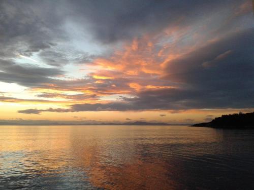 a sunset over a large body of water at Koutadelias rooms in Kálamos
