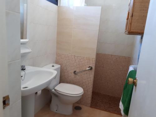a bathroom with a toilet and a sink at Dunes to explore and relax right by the desert wifi in Corralejo