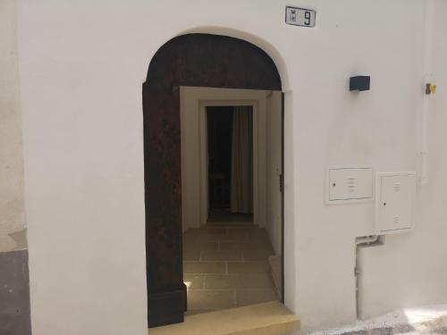 a hallway with an archway in a white wall at B & B San Giovanni 9 in Gallipoli