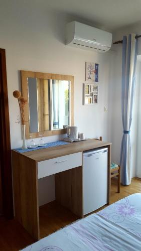 a bathroom with a sink and a mirror at Guesthouse Matušan's place in Rab