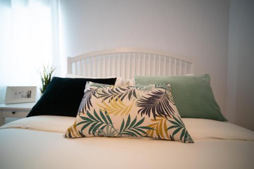 a bed with two pillows on top of it at O Melhor Sítio do Mundo - NOVO na Nazaré in Nazaré