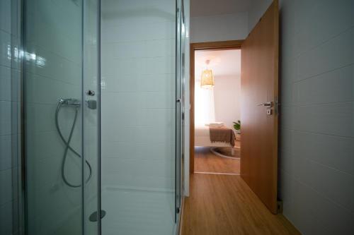 a bathroom with a shower and a glass door at O Melhor Sítio do Mundo - NOVO na Nazaré in Nazaré