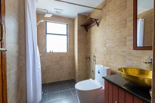a bathroom with a bowl sink and a toilet at Nivas Boutique Home in Kathmandu