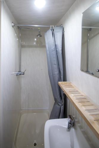 a bathroom with a shower and a toilet and a sink at MyRoomz Hollingdales Hotel in Blackpool