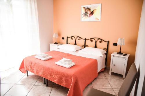 a bedroom with two beds and a red blanket at Dimora del Balì in Capurso