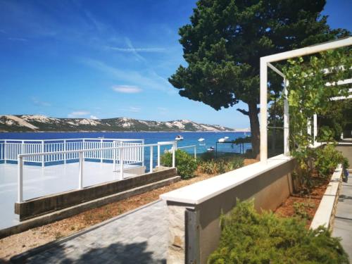 a house with a view of the water at Beachfront Apartments - Villa Vita in Stara Novalja