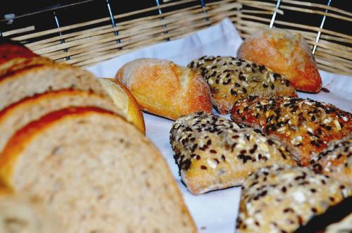 a group of breads and buns on a rack at Hotel Berthelot in Bucharest