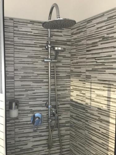 a shower with a shower head in a bathroom at Luxury Home Keops in Catania