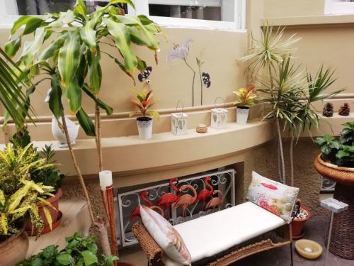 a room with potted plants and a fireplace at Casa Kilig in Santa Cruz de Tenerife