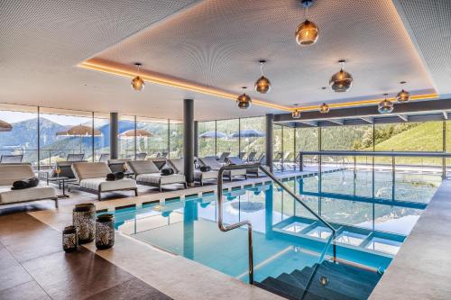 a swimming pool with a view of the mountains at Boutique Hotel Kircher in Sarntal