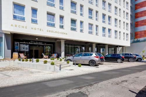 a hotel with cars parked in front of a building at Hotel Arche Geologiczna in Warsaw