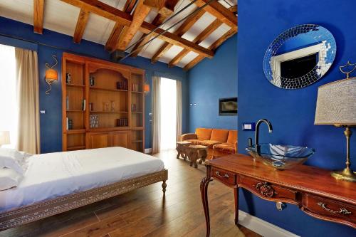 a bedroom with blue walls and a bed and a table at Tenuta Lisetta in Monterotondo
