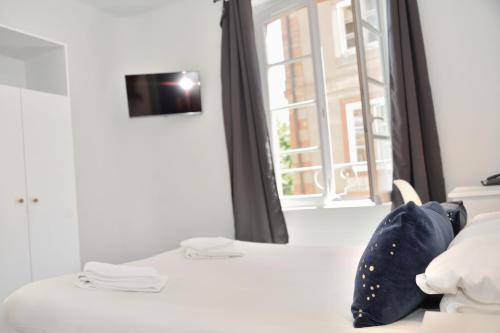 a room with a bed and a window at Hotel des Arts - Centre Cathédrale in Strasbourg