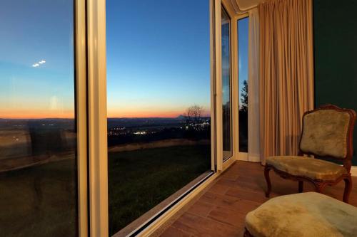 a room with a window with a chair and a view at Tenuta Lisetta in Monterotondo