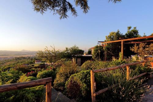 a view from the garden of a house with a wooden fence at Tenuta Lisetta in Monterotondo