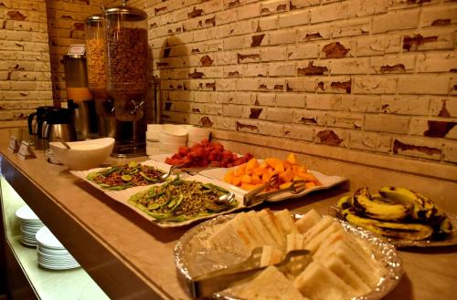 a buffet with several plates of food on a counter at Hotel City Inn in Varanasi