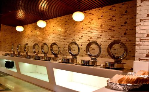a row of pans on a counter in a room at Hotel City Inn in Varanasi