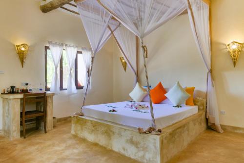 Un pat sau paturi într-o cameră la Zanzibar Pearl - Boutique Hotel & Villas