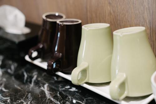 two cups sitting on a plate on a counter at The Stay Inn in Kenting