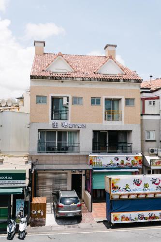 a building with a car parked in front of it at The Stay Inn in Kenting