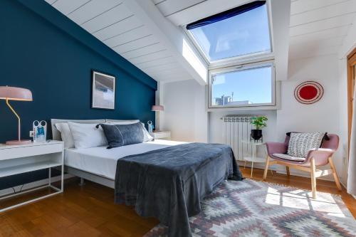 a bedroom with a bed and a blue wall at Sweet Inn - Sempione in Milan