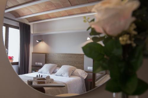 a bedroom with a bed and a mirror at Rosella by CASALEA in Morella