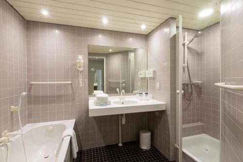 Ένα μπάνιο στο Fletcher Hotel-Restaurant Oud London