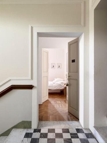 a white room with a door leading to a bedroom at Le dimore de Il borgo del balsamico in Albinea