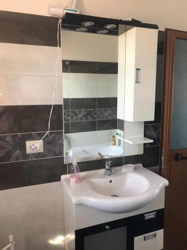 a bathroom with a sink and a mirror at SARA'S VILLA in Shkodër