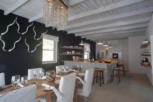 a dining room with a table and chairs and a chandelier at Qambathi Mountain Lodge in Kamberg Valley
