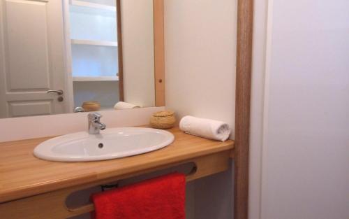 a bathroom with a sink and a mirror at VVF Landes Moliets in Moliets-et-Maa