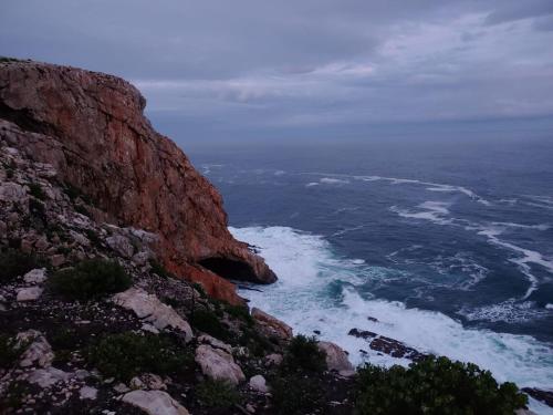 an aerial view of the ocean from a mountain at TNiqua Stable Inn in Plettenberg Bay