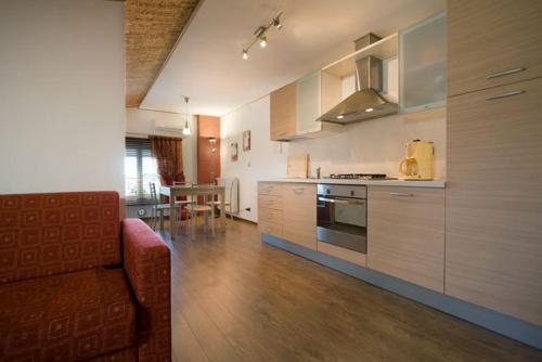 a kitchen with a couch and a table in a room at Al Gallo Cividale- mansarda o piano terra in Cividale del Friuli