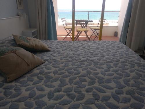 a bedroom with a bed with a view of the ocean at Best Sea View Monte Gordo in Monte Gordo