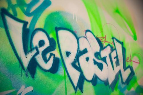 a wall with some graffiti on it at Hôtel le Pastel in Toulouse