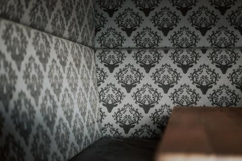 a room with a wall with black and white wallpaper at Rufana Alpin in Bürserberg