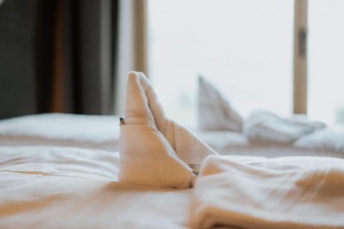 a group of white sheets on a bed at Rufana Alpin in Bürserberg