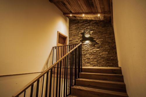 a staircase in a building with a stone wall at Rufana Alpin in Bürserberg