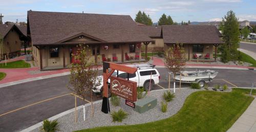a sign in front of a house with a boat at Golden Stone Inn in West Yellowstone