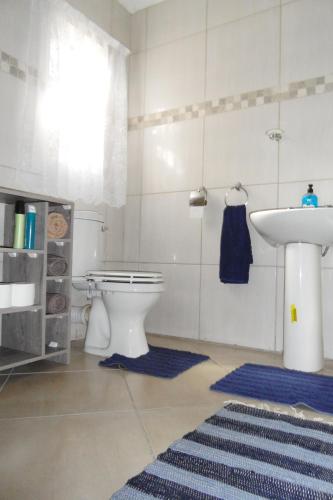 a bathroom with a toilet and a sink at Garden Wing in Upington