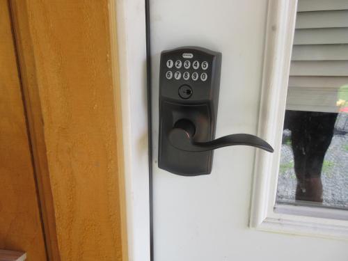 a black door handle on a door with a cat outside at Chateau Tina in the Catskill Mountains in East Durham