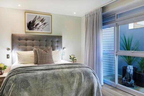 A bed or beds in a room at Beta Beach Villa @ Camps Bay