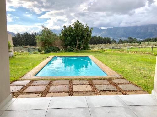 a swimming pool in the middle of a yard at The Barn in Franschoek in Franschhoek