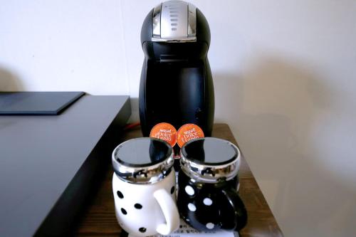 a pair of boots sitting on a table next to a blender at Hotel Yam in Daejeon