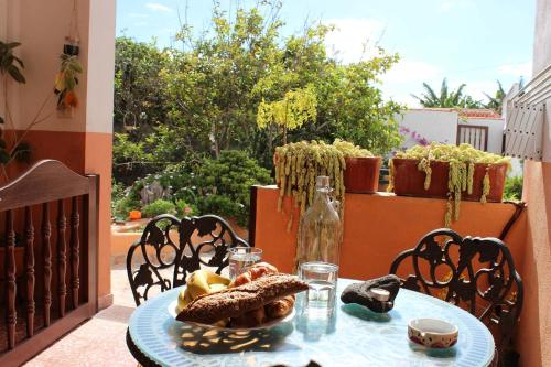 a table with a plate of food on a balcony at Casa Los Palitos in Monte de Breña