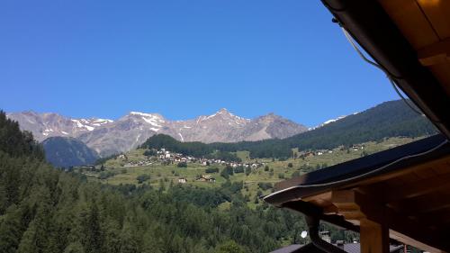 a view of a valley with mountains in the background at Hotel Ortles Dolomiti Walking & Spa in Cogolo
